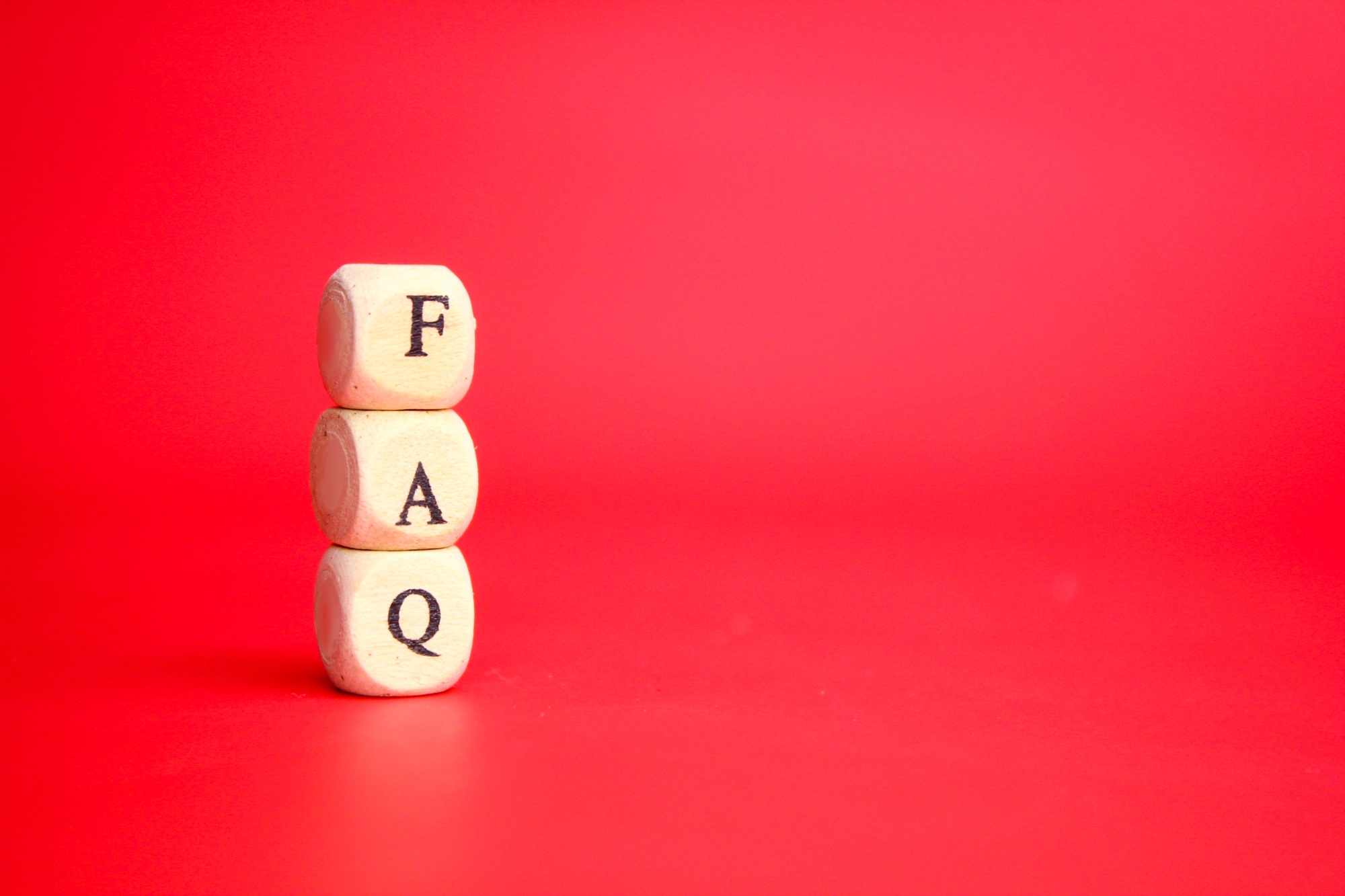 wooden cube with the letters FAQ